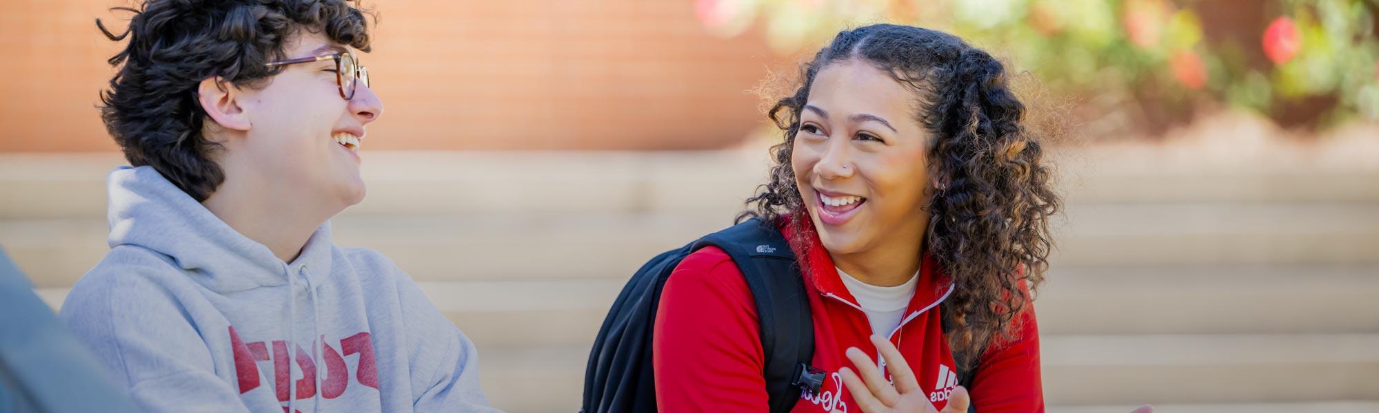 Two students talking near student center